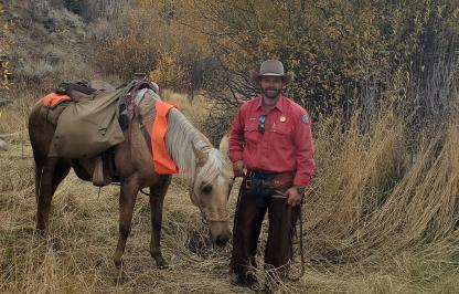 Levi Wood, South Cody Game Warden leading a pack horse 