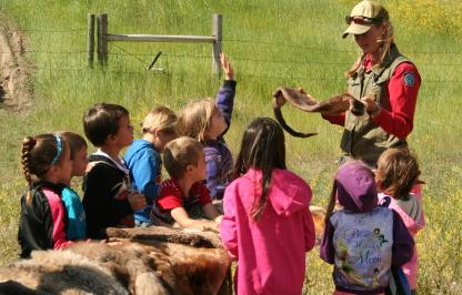 A Wyoming Game and Fish Warden teaches a group of students about wildlife.