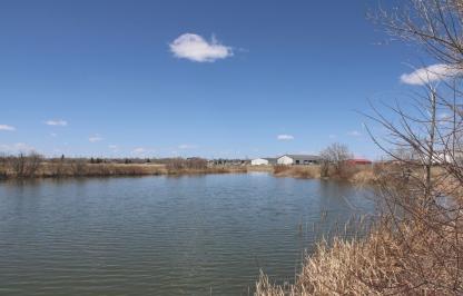 A landscape photo of pasture pond on the campus of Laramie County Community College.