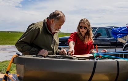 Game and Fish personnel check watercraft for AIS at a check station.