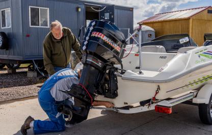 AIS check station employee checks watercraft.