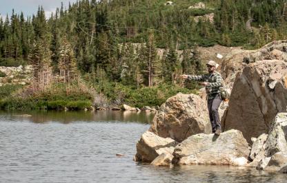 Angler fishing in the snowy mountain range