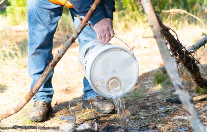 Man putting out fire safely