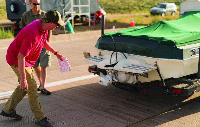 A Wyoming Game and Fish aquatic invasive species inspector checks a watercraft to ensure it is safe for Wyoming waterways.