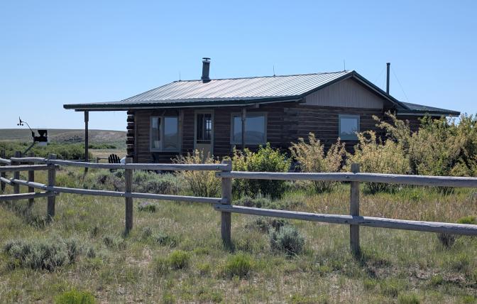 A ranch house with a fenced yard.