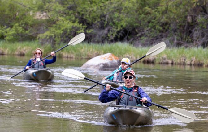 Participants in the Becoming and Outdoorswoman Camp take kayaks out on the water.