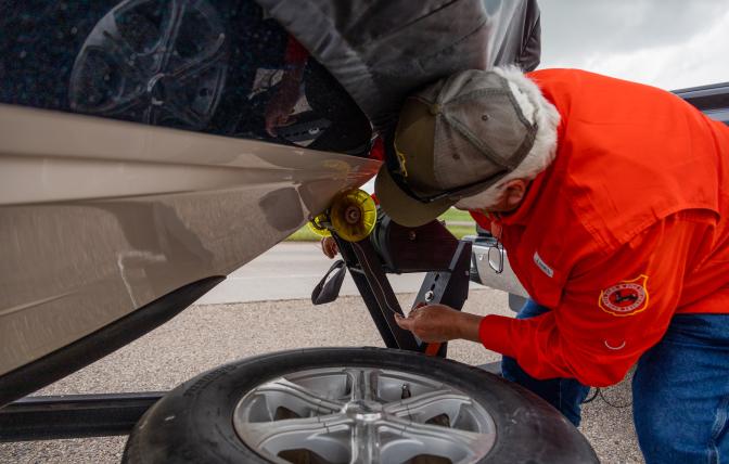 AIS inspector checks watercraft for invasive species before entering Wyoming.
