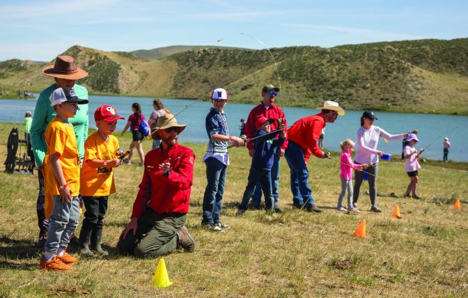 Wyoming Game and Fish Department fisheries staff help kids hone their fishing skills at the Maury Brown kids fishing day outside of Cheyenne in June 2024.