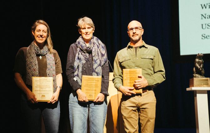 Aly Courtemanch (left), Sarah Dewey (center), and Eric Cole (right) accept the Craighead Conservation Award at the 2026 Northern Rockies Conservation Symposium (courtesy of Northern Rockies Conservation Cooperative).