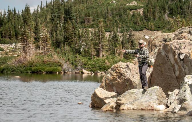Angler fishing in the snowy mountain range